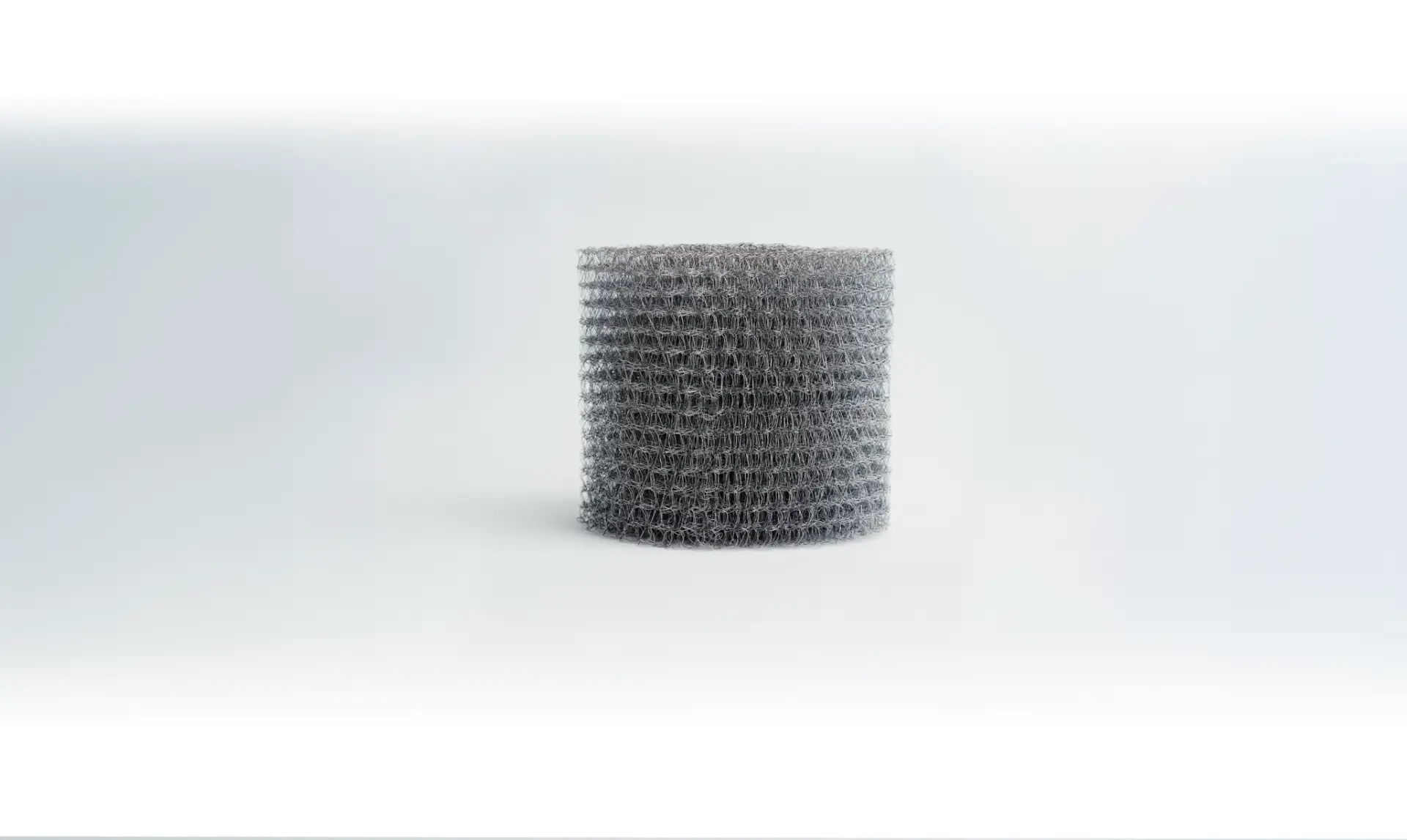 Cylindrical wound filter with performance features and configurable knitted mesh structure